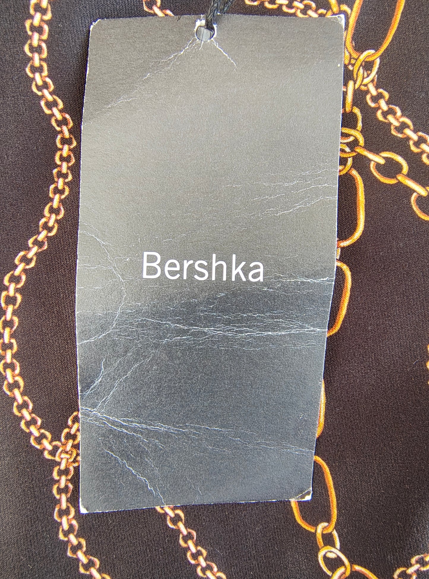 D'OCCASION – Combinaison noire à imprimé chaîne dorée de BERSHKA (taille S)
